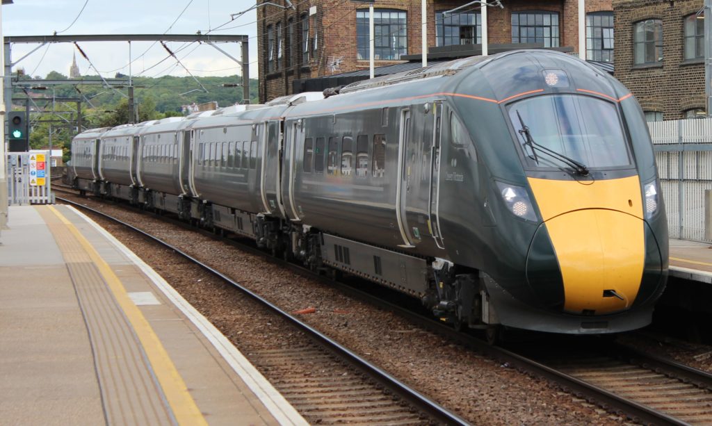 A 5-car Class 800 train, named Queen Victoria, in Great Western Railway livery passing through Kentish Town West ation